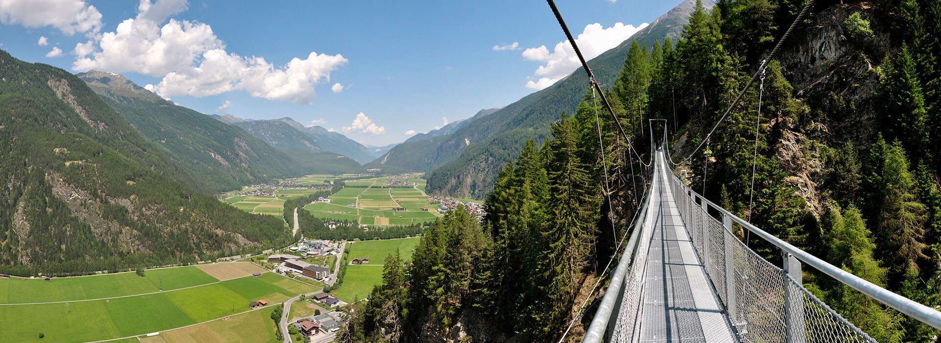 Suspension bridge with a view of Längenfeld and the Ötztal